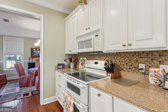 kitchen featuring ornamental molding, white appliances, tasteful backsplash, and a notable chandelier