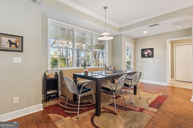 dining area featuring baseboards, visible vents, ornamental molding, and plenty of natural light