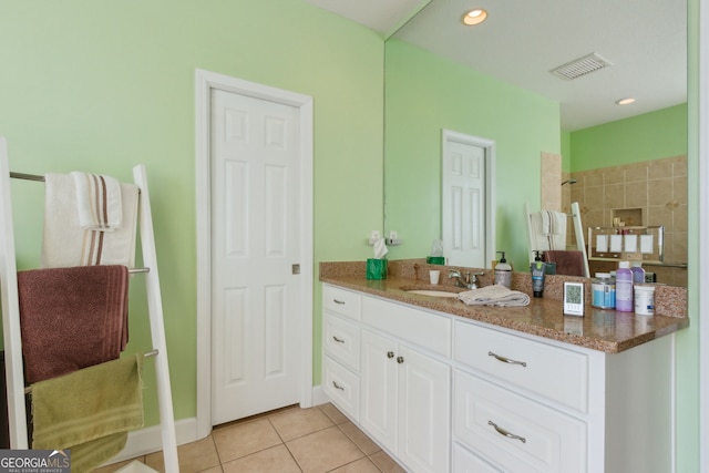 full bathroom featuring tile patterned flooring, vanity, recessed lighting, visible vents, and tiled shower