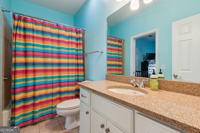 bathroom with vanity, tile patterned flooring, toilet, and curtained shower