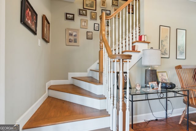 stairs featuring baseboards and wood finished floors
