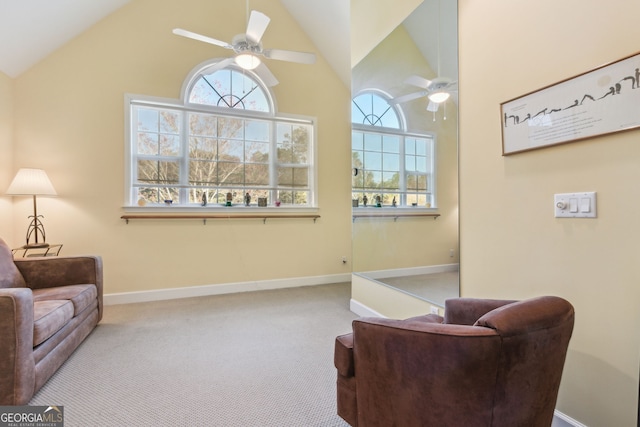 sitting room featuring carpet floors, a ceiling fan, and a wealth of natural light