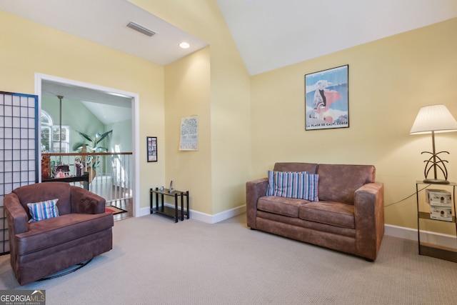 living area with visible vents, baseboards, carpet floors, and vaulted ceiling