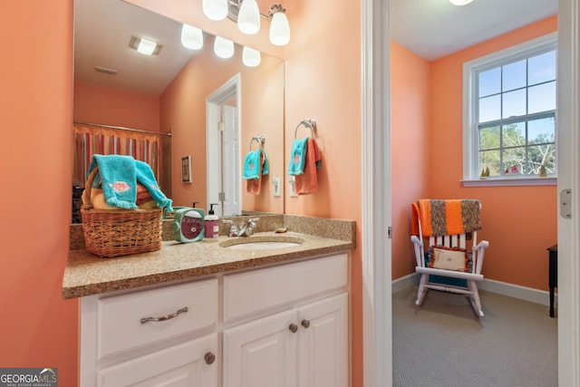 bathroom with vanity and baseboards