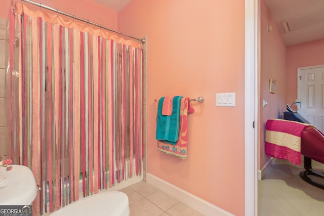 bathroom with tile patterned floors, baseboards, a shower with curtain, and toilet