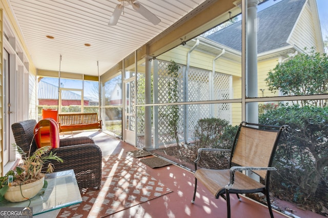 sunroom featuring a ceiling fan
