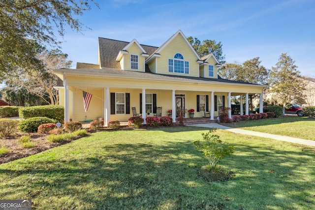 farmhouse featuring covered porch, a shingled roof, and a front lawn