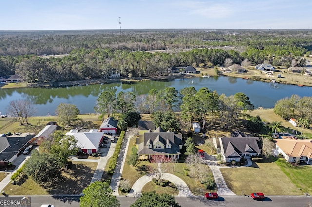 drone / aerial view with a water view, a residential view, and a wooded view