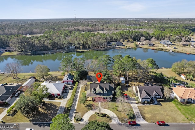 drone / aerial view featuring a residential view, a water view, and a wooded view