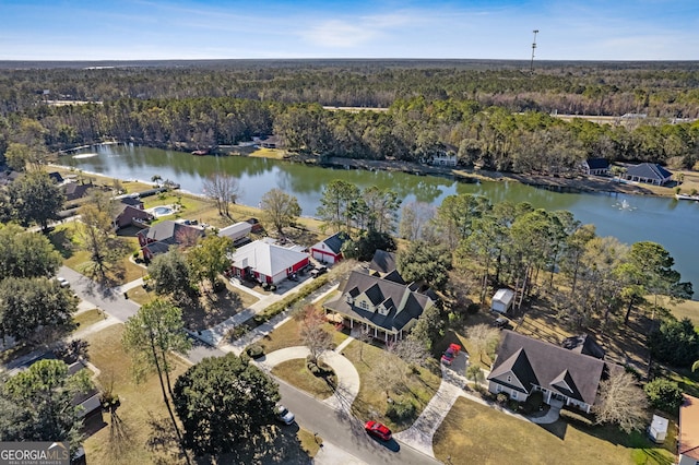 bird's eye view featuring a residential view, a water view, and a wooded view