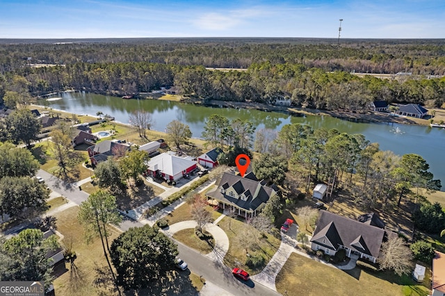 drone / aerial view featuring a water view and a view of trees