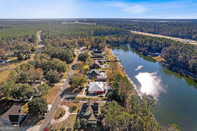 bird's eye view with a view of trees and a water view