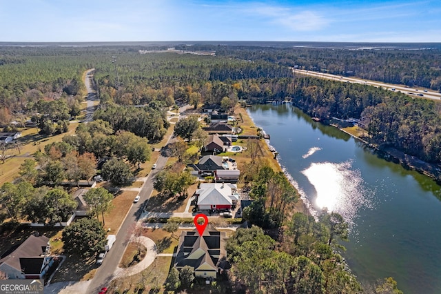 drone / aerial view with a water view and a wooded view