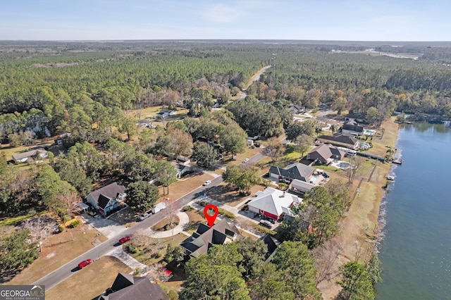 drone / aerial view featuring a water view and a view of trees