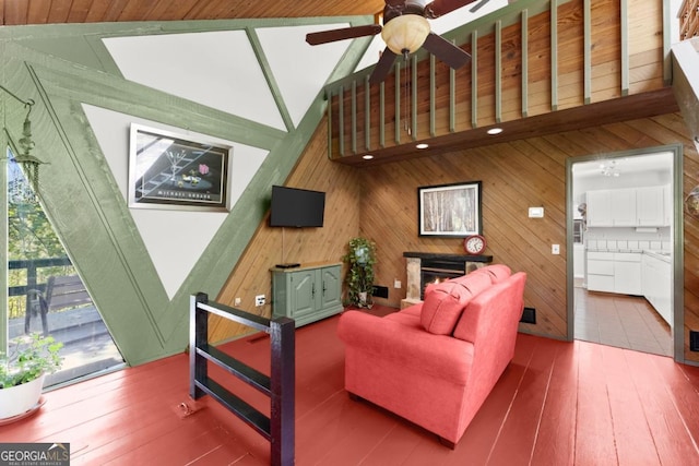 115 Rabbit Run, Dawsonville, GA 30534 - living room with ceiling fan, wood walls, hardwood / wood-style floors, vaulted ceiling, and a lit fireplace