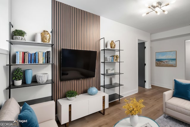 living area with baseboards and wood finished floors