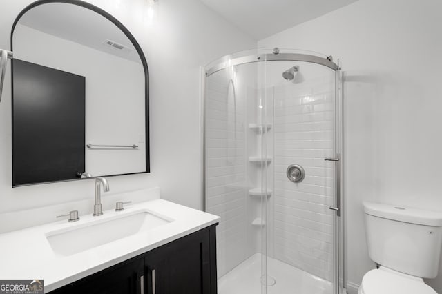 bathroom with toilet, visible vents, a shower stall, and vanity