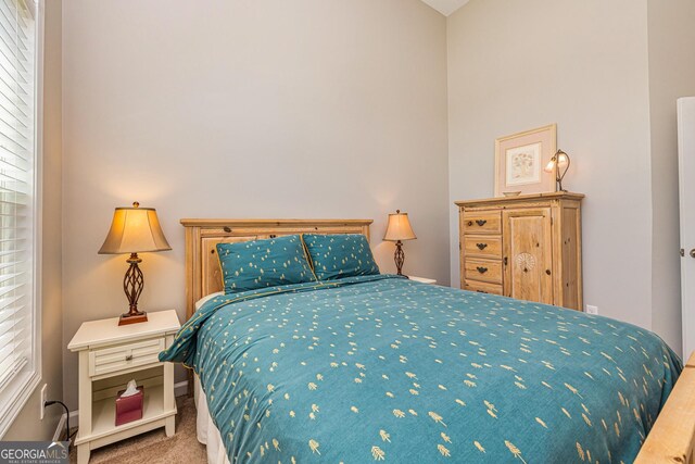 carpeted bedroom featuring baseboards