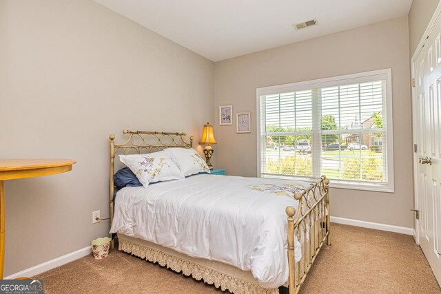 carpeted bedroom featuring lofted ceiling and baseboards