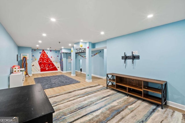 recreation room with recessed lighting, baseboards, and wood finished floors