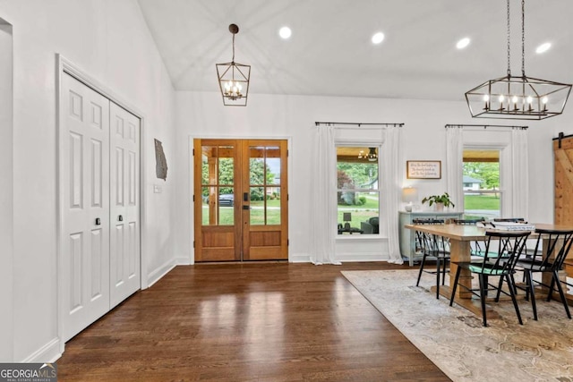 entryway featuring french doors, recessed lighting, wood finished floors, and a notable chandelier