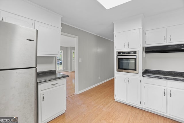 115 Linda Way, Fayetteville, GA 30215 - kitchen with dark countertops, exhaust hood, stainless steel appliances, and light wood-type flooring