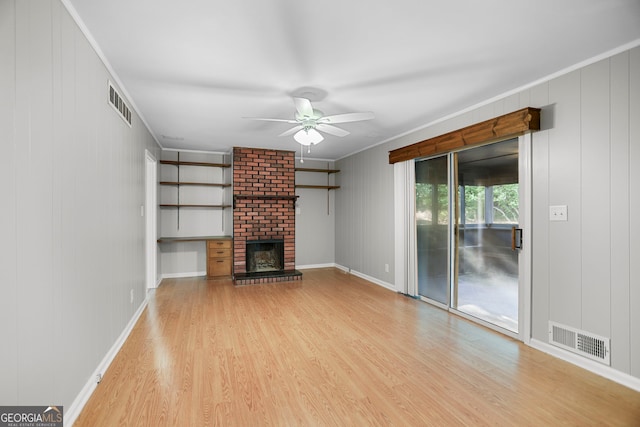 115 Linda Way, Fayetteville, GA 30215 - unfurnished living room with a brick fireplace, a ceiling fan, visible vents, and wood finished floors