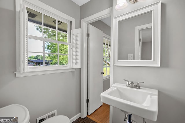 115 Linda Way, Fayetteville, GA 30215 - half bathroom featuring toilet, visible vents, a sink, and wood finished floors