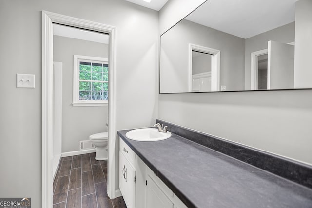 115 Linda Way, Fayetteville, GA 30215 - bathroom with visible vents, vanity, wood finished floors, toilet, and baseboards