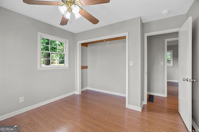 115 Linda Way, Fayetteville, GA 30215 - unfurnished bedroom with baseboards, a closet, wood finished floors, and multiple windows