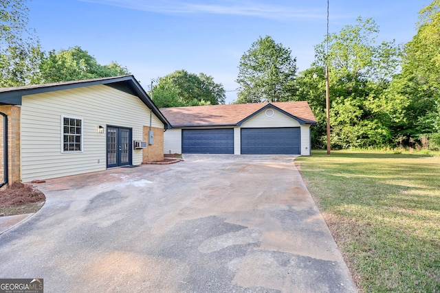 115 Linda Way, Fayetteville, GA 30215 - view of front of house with a detached garage, brick siding, french doors, and a front yard
