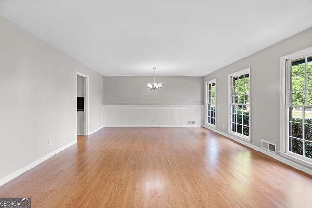 115 Linda Way, Fayetteville, GA 30215 - unfurnished room with a wainscoted wall, a notable chandelier, light wood-style flooring, and visible vents