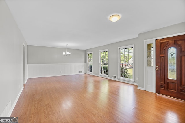 115 Linda Way, Fayetteville, GA 30215 - foyer entrance with light wood-type flooring, a wainscoted wall, a chandelier, and visible vents