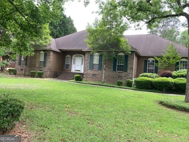 140 Cedar Creek Dr, Dublin, GA 31021 - ranch-style home with a front lawn