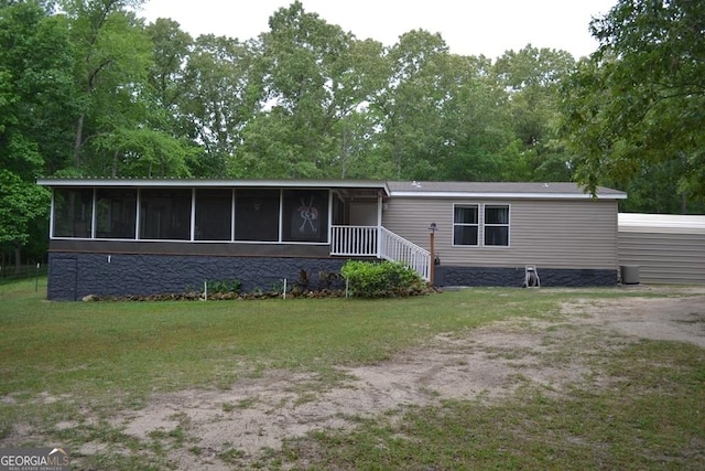 manufactured / mobile home with a sunroom and a front yard