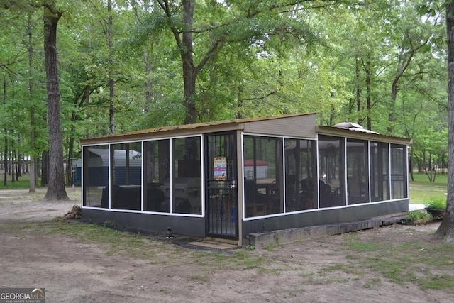 view of outbuilding with a sunroom
