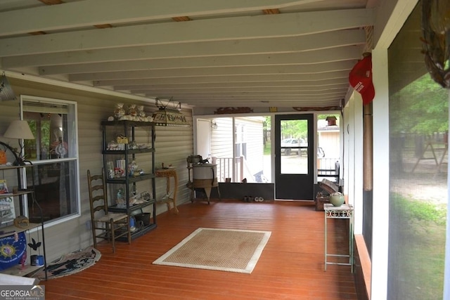 sunroom / solarium with beamed ceiling and a healthy amount of sunlight