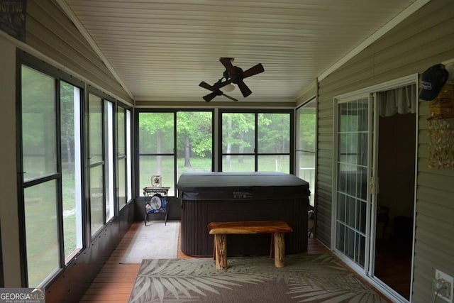 sunroom with a ceiling fan and a hot tub