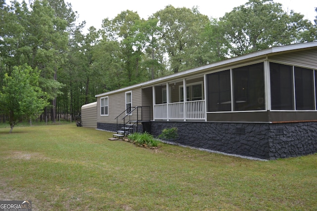 view of front facade featuring a sunroom and a front yard