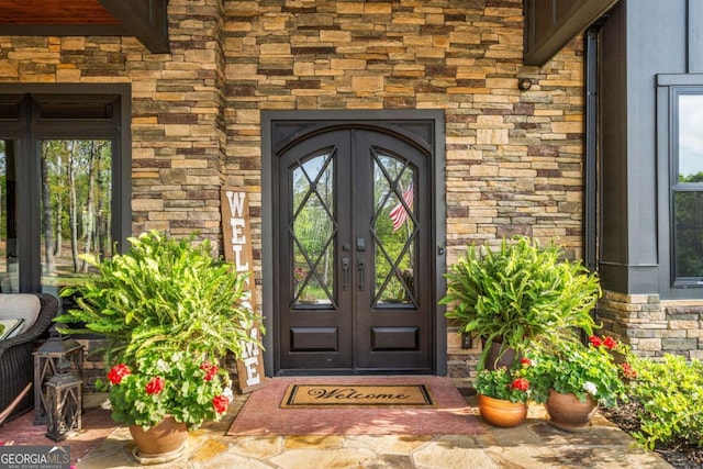 281 Abbott Dr, Canton, GA 30114 - entrance to property featuring french doors, stone siding, and brick siding