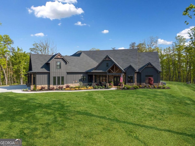 281 Abbott Dr, Canton, GA 30114 - craftsman-style house featuring board and batten siding, a front yard, and stone siding