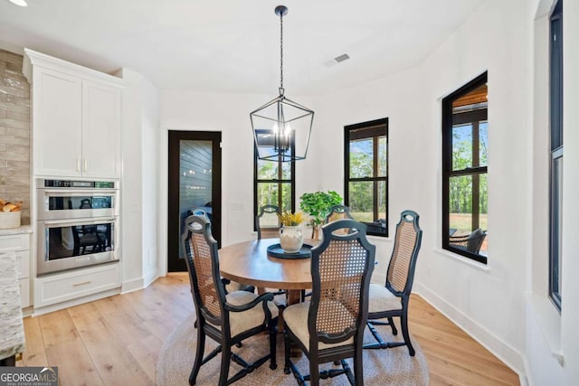 281 Abbott Dr, Canton, GA 30114 - dining area featuring light wood-style flooring, a chandelier, and baseboards