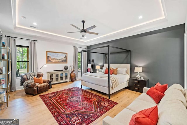281 Abbott Dr, Canton, GA 30114 - bedroom featuring a tray ceiling, wood finished floors, a ceiling fan, and recessed lighting