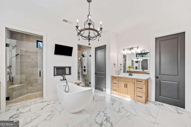 281 Abbott Dr, Canton, GA 30114 - bathroom with a chandelier, a stall shower, vanity, a freestanding tub, and marble finish flooring