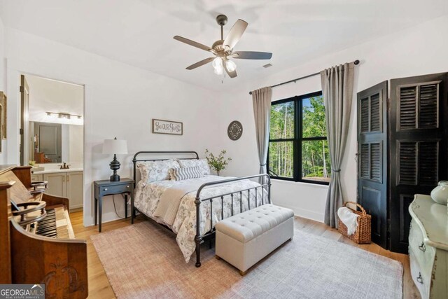 281 Abbott Dr, Canton, GA 30114 - bedroom featuring light wood finished floors, ceiling fan, and connected bathroom