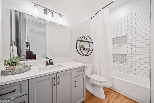 281 Abbott Dr, Canton, GA 30114 - bathroom with vanity, toilet, wood finished floors, and shower / bath combo with shower curtain