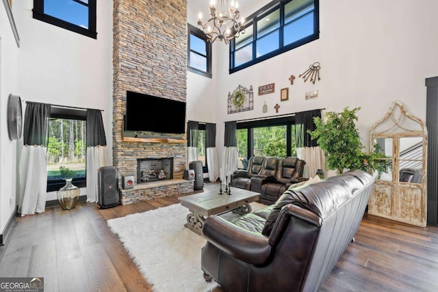 281 Abbott Dr, Canton, GA 30114 - living area featuring a high ceiling, a chandelier, wood finished floors, and a stone fireplace