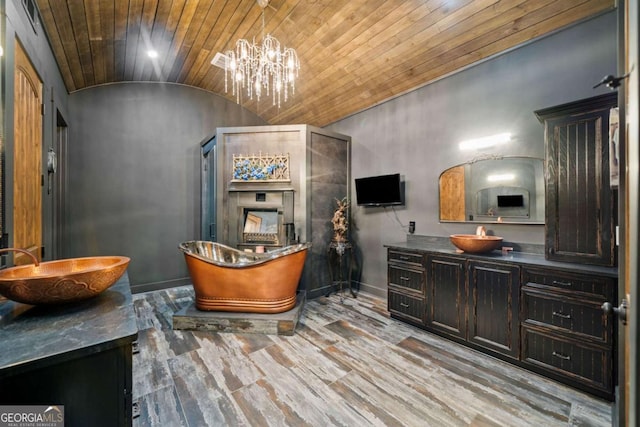 281 Abbott Dr, Canton, GA 30114 - bathroom with lofted ceiling, vanity, wooden ceiling, a freestanding tub, and baseboards