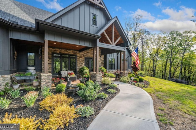 281 Abbott Dr, Canton, GA 30114 - doorway to property with board and batten siding, covered porch, and a shingled roof