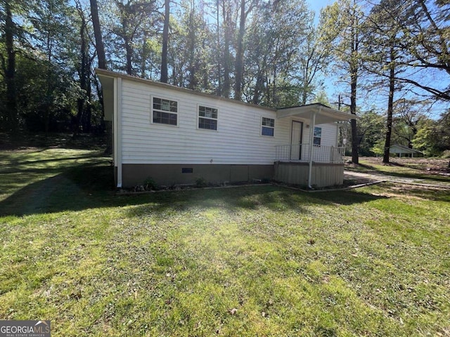 manufactured / mobile home with crawl space and a front lawn